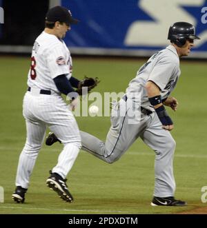 Seattle Mariners' Ichiro Suzuki, of Japan, right, is greeted at home by  teammates Jeremy Reed, left, and Yuniesky Betancourt, after hitting a  three-run homer off Los Angeles Angels pitcher Kevin Gregg in