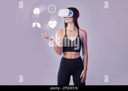 Woman in Sports Bra Holding a Virtual Reality Headset · Free Stock Photo