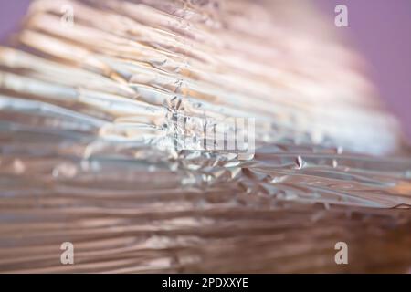 Blurred background, close up of a shiny colorful surface with geometric lines, texture Stock Photo