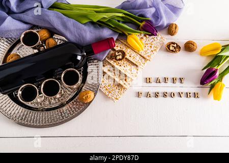 round silver tray with glasses of red wine, matzah, walnuts, a bottle of wine. flat layout. the concept of the Jewish Passover holiday Stock Photo