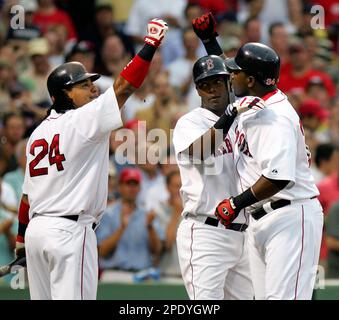 Boston Red Sox's David Ortiz, right, receives congratulations from Manny  Ramirez (24) with Edgar Renteria in the middle after Ortiz hit a three-run  homer in the eighth inning against the Chicago White