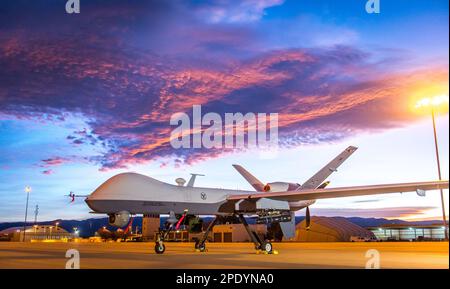 General Atomics MQ-9 Reaper drone flying over the mountains at sunset ...