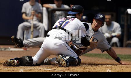 Los Angeles Dodgers' Paul Lo Duca, right, scores against Milwaukee Brewers'  Chad Moeller in the ninth inning to put his team on the score board Monday,  May 31, 2004, at Dodgers Stadium