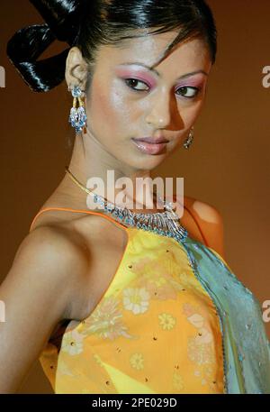 An Indian model displays various brands of jewelry during a