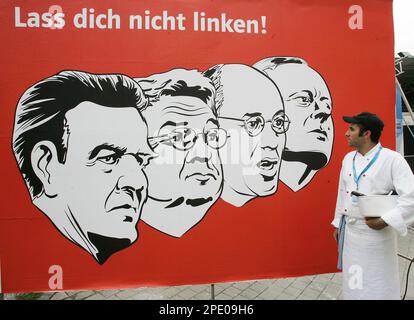 A man walks past an election campaign poster of the Christian Social Union party (CSU) in Munich, southern Germany, Saturday, July 30, 2005 showing German Chancellor Gerhard Schroeder, Foreign Minister Joschka Fischer andthe top runners for Germany's new left party Gregor Gysi and Oskar Lafontaine, from left, in socialist style, at the start of the campaign for Germany's federal elections on September 18, 2005. Poster reads: 'Don't be cheated'. (AP Photo/Diether Endlicher)