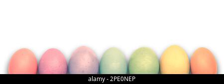Line of rainbow colored pastel Easter eggs isolated on white background, Easter web banner with copy space Stock Photo