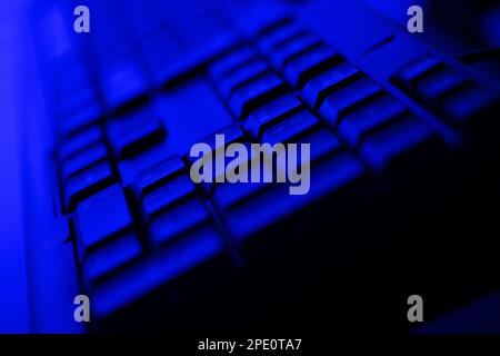 Dark Blue Illuminated Desktop Computer Keyboard Close Up Stock Photo
