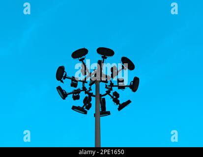 A modern street light in a crisp blue sky Stock Photo