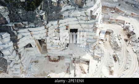 Heavy machines working at a huge marble quarry in Europe. Transporting the marble blocks. Stock Photo