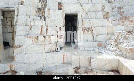 Heavy machines working at a huge marble quarry in Europe. Transporting the marble blocks. Stock Photo