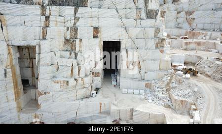 Heavy machines working at a huge marble quarry in Europe. Transporting the marble blocks. Stock Photo