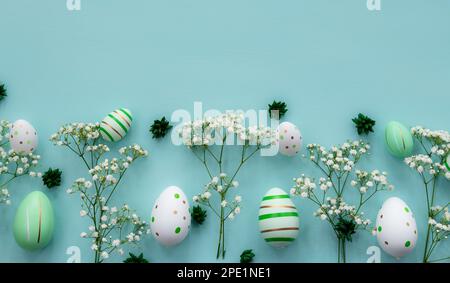 Flat lay easter composition with flowers and eggs on a green background. Banner,  greetings card. Stock Photo