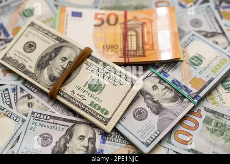 200 Euro banknote next to 50 euros on top of one hundred dollar bills. Trading Euro with Dollar Stock Photo
