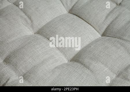 Gray upholstered furniture textile background. Soft, comfortable armchair seat close-up Stock Photo