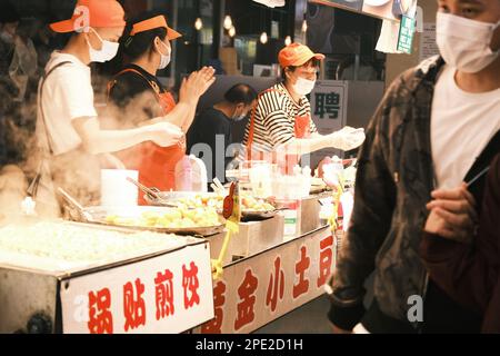 A market with people making and selling korean food Stock Photo