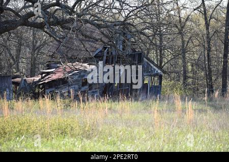 An old abandoned building on a cattle farm in Missouri, MO, United States, US, USA, is slowing falling down as it surrenders to time and the elements. Stock Photo