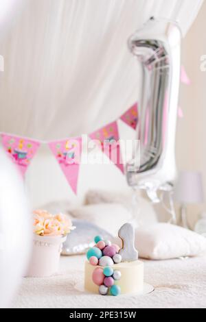 One year birthday decorations for beautiful girl. Girls style. A lot of balloons pink and white style. Stock Photo