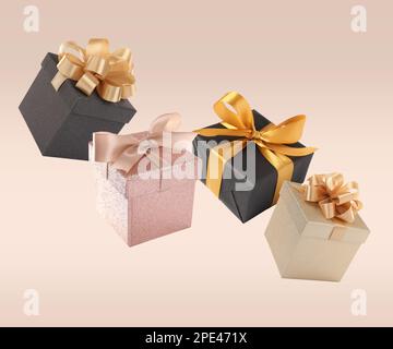 Beautifully wrapped gift boxes flying on beige background Stock Photo