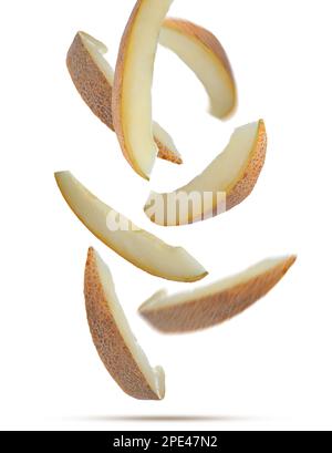 Pieces of delicious ripe melon falling on white background Stock Photo