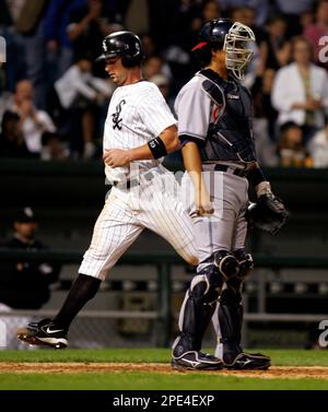 Chicago White Sox' Aaron Rowand is congratulated by Paul Konerko, far  right, after scoring on a sacrifice fly hit by Joe Crede in the second  inning of Game 5 of the American