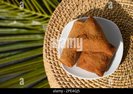 Sri Lankan Chinese Rolls , egg and fish roll different shape, short eats in white plate on palm leaf. Authentic street food deep fried. Top view, copy Stock Photo