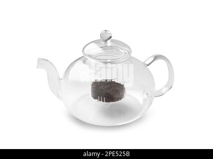 Empty glass transparent teapot and dry green tea in it on a white background. Utensils for making tea. Stock Photo