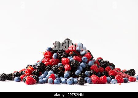 Fresh organic berries close-up isolated. Colorful composition of blueberries, raspberries, blackberries on a white background. Useful berries. Stock Photo