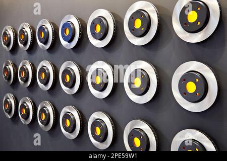 Brake discs on the wall of exhibition store Stock Photo