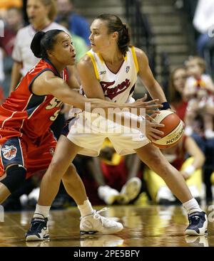 Charlotte Sting's Dawn Staley, left, drives to the basket against