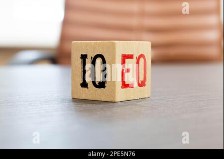 Wooden cubes with the expression 'IQ' 'Intelligence Quotient' to 'EQ' 'Emotional Quotient'. Beautiful grey background. Copy space. Concept. Stock Photo