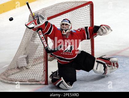 Canada's goaltender Martin Brodeur makes a glove save against Switzerland  during first period mens ice hockey