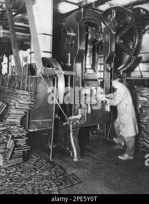 A power press at the Birmingham Small Arms Company Limited factory, c1933. The power press can be seen making motorcycle engine parts for BSA Motorcycles. Stock Photo