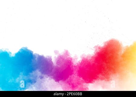 Multi colour powder explosion on white background. Launched colourful dust particles splashing. Stock Photo