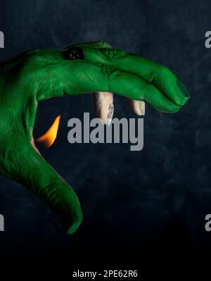 Hand painted green and white, with a flame coming out and a button, simulating a fire-breathing dragon Stock Photo