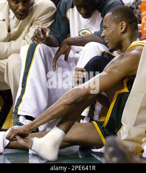 Seattle SuperSonics' Rashard Lewis holds up his shoes before throwing them  into the cheering crowd following the Sonics' 97-72 win over the New  Orleans Hornets on Friday, April 15, 2005, in Seattle.
