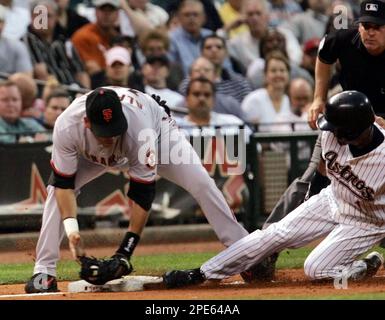 Houston Astros' Willy Taveras, bottom, slides safely into third for a  triple past Cincinnati Reds third baseman Joe Randa during the sixth inning  Friday, April 15, 2005, in Cincinnati. (AP Photo/David Kohl