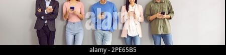 Group of happy young people using smartphones for text messaging or watching videos Stock Photo