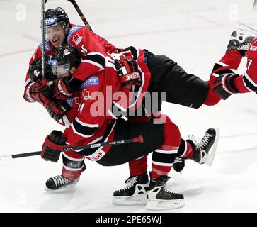 Team Canada's Ryan Smyth, left, vies for the puck with Fribourg's Shawn  Heins, right, during the semi-final match between Team Canada and HC  Fribourg Gotteron at the 86th Spengler Cup ice hockey tournament, in Davos,  Switzerland, Sunday, Dec. 30