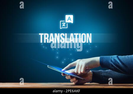 A person uses a translator to communicate on the Internet through a tablet. Stock Photo