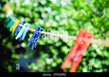 Set of clothes hangers located in the same position. The blue clothes stick is in focus Stock Photo
