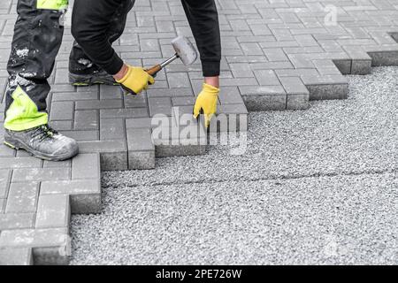 rubber hammer for adjusting the lock paving on the sidewalk Stock Photo