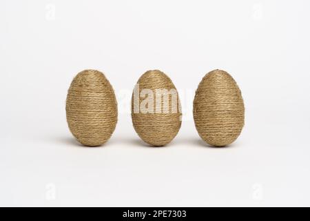Hand wrapped easter eggs with jute twine, isolated white background. Studio Stock Photo