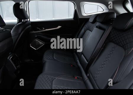 Modern car interior. Clean rear seats with the belts. Three rear seats ...
