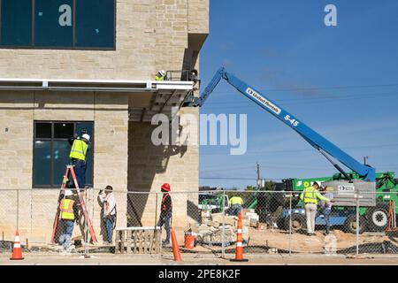 Galveston, Texas, USA - February 2023: Construction workers on a new building development on the city's seafront Stock Photo