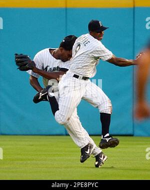 Florida Marlins' Juan Pierre is congratulated by teammate Derrek