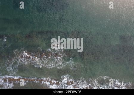 Stones rock and reef in green sea water aerial above top view Stock Photo