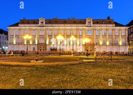 Baroque Palace (Palatul Baroc) in Piata Unirii (Union Square), Timisoara, Romania at night. Currently housing the National Museum of Art, it dates to Stock Photo