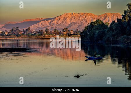Looking out, at sunrise over the Nile River toward the West Bank in Luxor Stock Photo