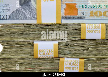 Close up side view of 4 straps of ten thousand, one hundred US dollar bills stacked on top of each other Stock Photo
