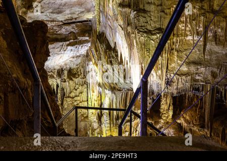 Prometheus Cave Natural Monument - largest cave in Georgia with stalactites and stalagmites, colorful illuminated rock formations and staircase. Stock Photo